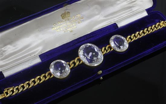 An early 20th century 15ct gold chain link bracelet set with three oval facet cut rock crystals, in fitted C. Packer & Co box,